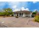 Charming single-story home featuring a covered porch, landscaped front yard with decorative rock, and flowering bushes at 8143 E Whitton Ave, Scottsdale, AZ 85251