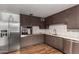 Modern kitchen featuring stainless steel appliances, subway tiles, and ample counter space at 8143 E Whitton Ave, Scottsdale, AZ 85251