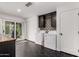 Bright laundry room featuring black hexagon tile floors, washer, and dryer at 8143 E Whitton Ave, Scottsdale, AZ 85251