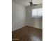 Empty bedroom featuring a window, ceiling fan, and wood flooring at 8520 E Mackenzie Dr, Scottsdale, AZ 85251