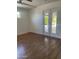 Bright bedroom featuring a ceiling fan, window, and a glass double door leading to the backyard at 8520 E Mackenzie Dr, Scottsdale, AZ 85251