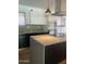 Bright kitchen featuring stainless steel appliances, modern fixtures, and a center island with countertop stove at 8520 E Mackenzie Dr, Scottsdale, AZ 85251