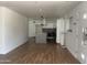 Bright, open-concept space with modern lighting, white walls, wood floors, and sleek kitchen at 8520 E Mackenzie Dr, Scottsdale, AZ 85251