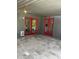 Charming covered patio with bright red doors and stone flooring at 8520 E Mackenzie Dr, Scottsdale, AZ 85251
