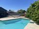 Relaxing backyard oasis featuring a pool, a hammock, and a lush landscape at 8520 E Mackenzie Dr, Scottsdale, AZ 85251