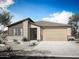Charming single-story home with neutral tones, brick accents, desert landscaping, and attached two car garage at 866 W Riparian Dr, San Tan Valley, AZ 85140