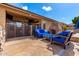 Inviting outdoor space with stone fireplace and blue cushioned seating at 870 E Megan St, Gilbert, AZ 85295