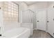 Clean bathroom featuring a soaking tub, step-in shower, neutral paint and white fixtures, creating a spa-like retreat at 870 E Megan St, Gilbert, AZ 85295