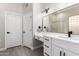 Bright bathroom featuring a double vanity, a large mirror, and modern matte black fixtures at 870 E Megan St, Gilbert, AZ 85295