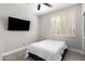 Cozy bedroom with wood-look floors, shuttered windows, and a wall-mounted TV at 870 E Megan St, Gilbert, AZ 85295