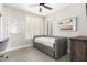Bedroom featuring natural light from shuttered windows, ceiling fan, and gray daybed at 870 E Megan St, Gilbert, AZ 85295