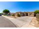 Single-story home with a two-car garage, desert landscaping and a concrete driveway at 870 E Megan St, Gilbert, AZ 85295