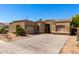 Single-story home with a two-car garage, desert landscaping and a concrete driveway at 870 E Megan St, Gilbert, AZ 85295