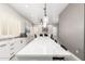 Open kitchen and dining area featuring an oversized island, modern lighting, and seamless flow between spaces at 870 E Megan St, Gilbert, AZ 85295