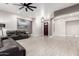 Open concept living room with tile floor and dark leather furniture at 870 E Megan St, Gilbert, AZ 85295