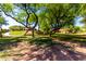 Shaded walking path through grassy common area with mature trees providing a serene and natural setting at 870 E Megan St, Gilbert, AZ 85295