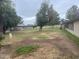 Expansive backyard with mature trees, lawn, and a view of the surrounding neighborhood at 10012 W Lakeview Cir, Sun City, AZ 85351
