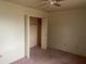 Neutral bedroom with carpeted floors, ample closet space, and ceiling fan at 10012 W Lakeview Cir, Sun City, AZ 85351