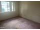 Neutral bedroom with carpeted floors, a bright window, and ample natural light at 10012 W Lakeview Cir, Sun City, AZ 85351