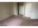Neutral bedroom with carpeted floors, a closet, and ample natural light at 10012 W Lakeview Cir, Sun City, AZ 85351