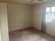 Bright bedroom featuring carpeted floors, neutral walls, and natural light at 10012 W Lakeview Cir, Sun City, AZ 85351