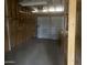 A peek inside this unfinished garage featuring a workbench, concrete floor, and paneled garage door at 10012 W Lakeview Cir, Sun City, AZ 85351