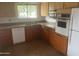 Functional kitchen with ample cabinet space, double basin sink, and standard appliances at 10012 W Lakeview Cir, Sun City, AZ 85351