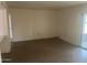 Bright living room with neutral walls, tile flooring, and sliding door access to a patio at 10012 W Lakeview Cir, Sun City, AZ 85351