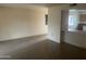Spacious living room featuring tile floors, neutral walls, and an open view to the kitchen at 10012 W Lakeview Cir, Sun City, AZ 85351