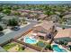 Aerial view of a home featuring a pool, mature landscaping, and a fully fenced backyard at 10308 E Osage Ave, Mesa, AZ 85212
