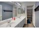Bright bathroom featuring double sinks, a large mirror, and vanity at 10308 E Osage Ave, Mesa, AZ 85212