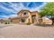 Beautiful two-story home showcasing well-manicured landscaping and an attached two-car garage at 10308 E Osage Ave, Mesa, AZ 85212