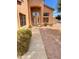 Inviting walkway leads to front door, showing mature landscaping and the home's facade at 10308 E Osage Ave, Mesa, AZ 85212