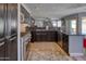 Spacious kitchen with dark cabinetry, granite countertops, and stainless steel appliances at 10308 E Osage Ave, Mesa, AZ 85212