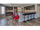 Open kitchen area with dark cabinets, granite counters, bar seating, and modern chairs at 10308 E Osage Ave, Mesa, AZ 85212