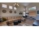 Spacious living area with a plush sectional, a chandelier, and several windows at 10308 E Osage Ave, Mesa, AZ 85212