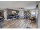 Large living room with hardwood floors, ceiling fan, and desk and shelves at 10308 E Osage Ave, Mesa, AZ 85212
