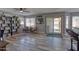 Living room featuring hardwood floors, a ceiling fan, and access to a patio with a pool view at 10308 E Osage Ave, Mesa, AZ 85212