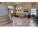 Bright living room featuring hard surface floors and a large sectional with steps nearby at 10308 E Osage Ave, Mesa, AZ 85212