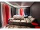 Modern living room featuring a large gray sectional couch and colorful curtains at 10308 E Osage Ave, Mesa, AZ 85212