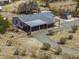 Aerial view of a well maintained home with an expansive driveway and various outbuildings at 10622 N Malachite Way, Casa Grande, AZ 85122