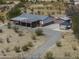 Aerial view of a home on a large lot, featuring a long driveway and multiple outbuildings at 10622 N Malachite Way, Casa Grande, AZ 85122