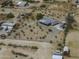 A drone shot of a ranch style house featuring an encircling driveway and multiple outbuildings at 10622 N Malachite Way, Casa Grande, AZ 85122