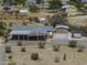 Aerial view of a rural property with a single-story home, large driveway and separate storage buildings at 10622 N Malachite Way, Casa Grande, AZ 85122