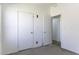 A standard bedroom with white walls and doors, and carpeted floor at 10622 N Malachite Way, Casa Grande, AZ 85122