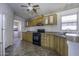A kitchen shows cabinets, appliances, and a view into the laundry room at 10622 N Malachite Way, Casa Grande, AZ 85122