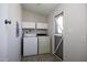 Functional laundry area with washer, dryer, storage cabinets, and natural light at 10622 N Malachite Way, Casa Grande, AZ 85122