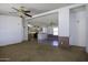 Open living room area with carpeted floors, view of kitchen, and a ceiling fan at 10622 N Malachite Way, Casa Grande, AZ 85122