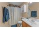 Bathroom featuring an updated vanity, decorative mirror, and shower with curtain at 11405 W Windsor Ave, Avondale, AZ 85392