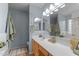Well lit bathroom features a spacious vanity, framed mirror and tiled floors at 11405 W Windsor Ave, Avondale, AZ 85392